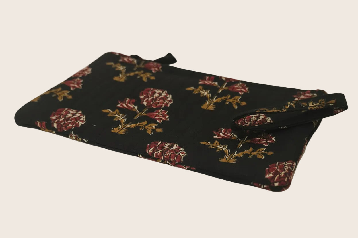 Floral-patterned pouch on a plain background