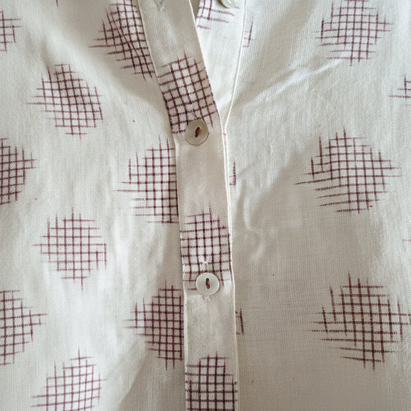 Close-up of a shirt with red ikat patterns 