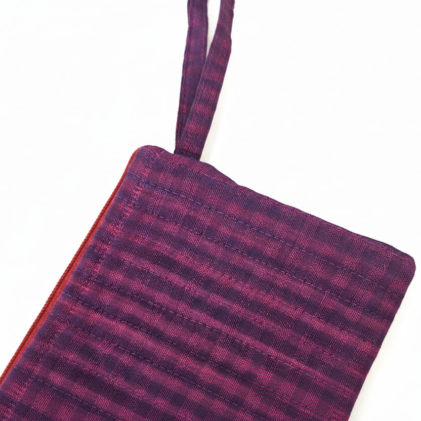 Plaid patterned pouch with a strap 